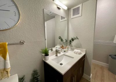 bathroom with a closet at liv+ gainesville apartments